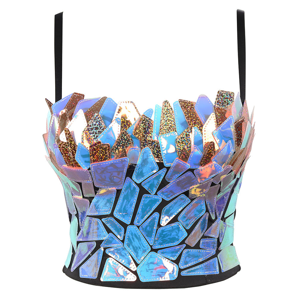 A black spaghetti-strap crop top with a striking mosaic design, completely covered in irregular, iridescent shards of reflective material in shimmering shades of electric blue, turquoise, purple, pink, and metallic gold. The fragmented, crystalline pieces create a dazzling, broken-glass effect with holographic glitter highlights, giving the fitted bustier-style top a bold, futuristic, and artistic appearance.