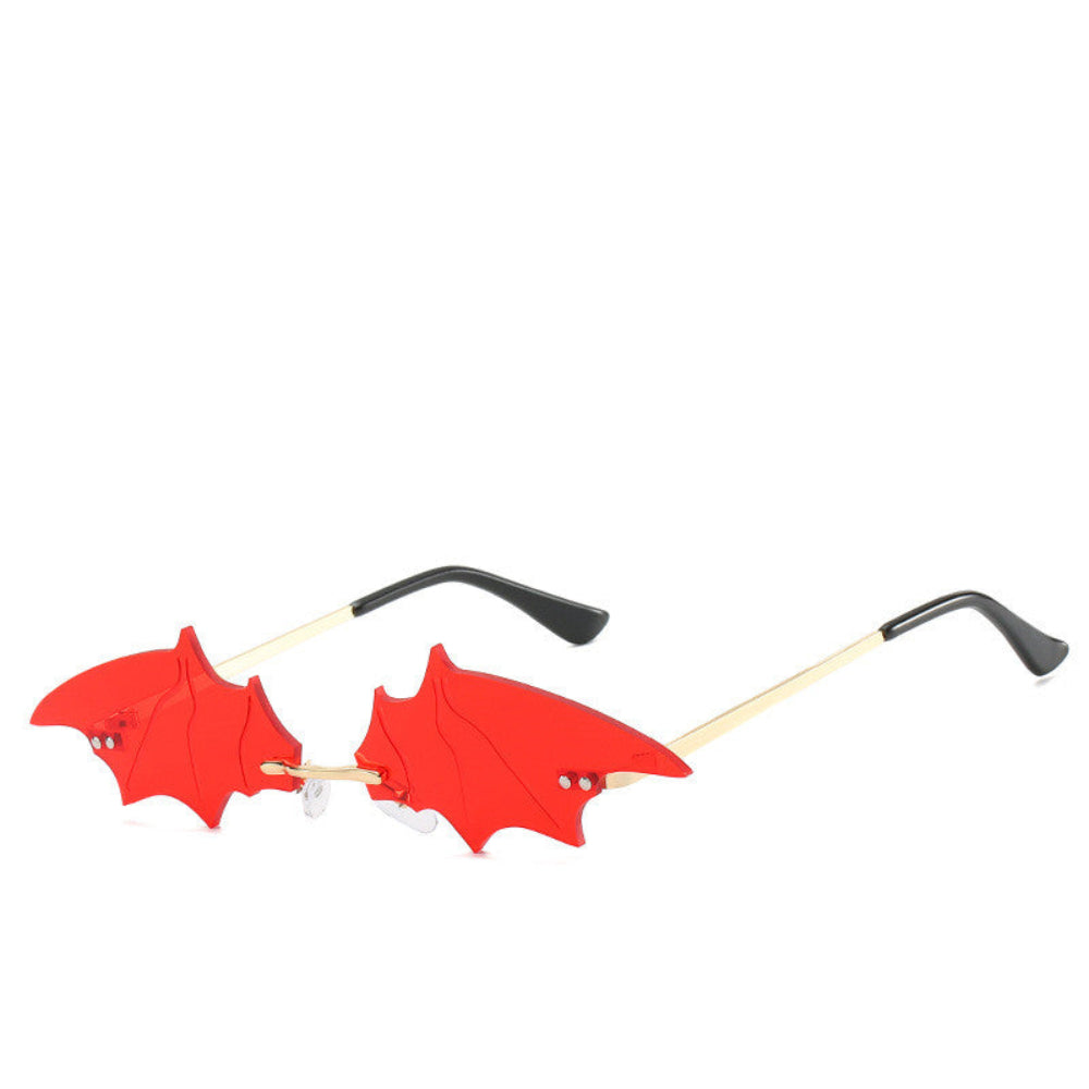 Rimless red bat-wing sunglasses with gold temples, product photo on a white background.