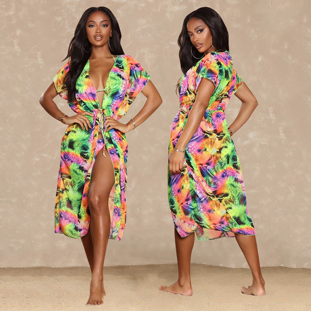 Woman wearing a colorful tie-dye dress against a beige background