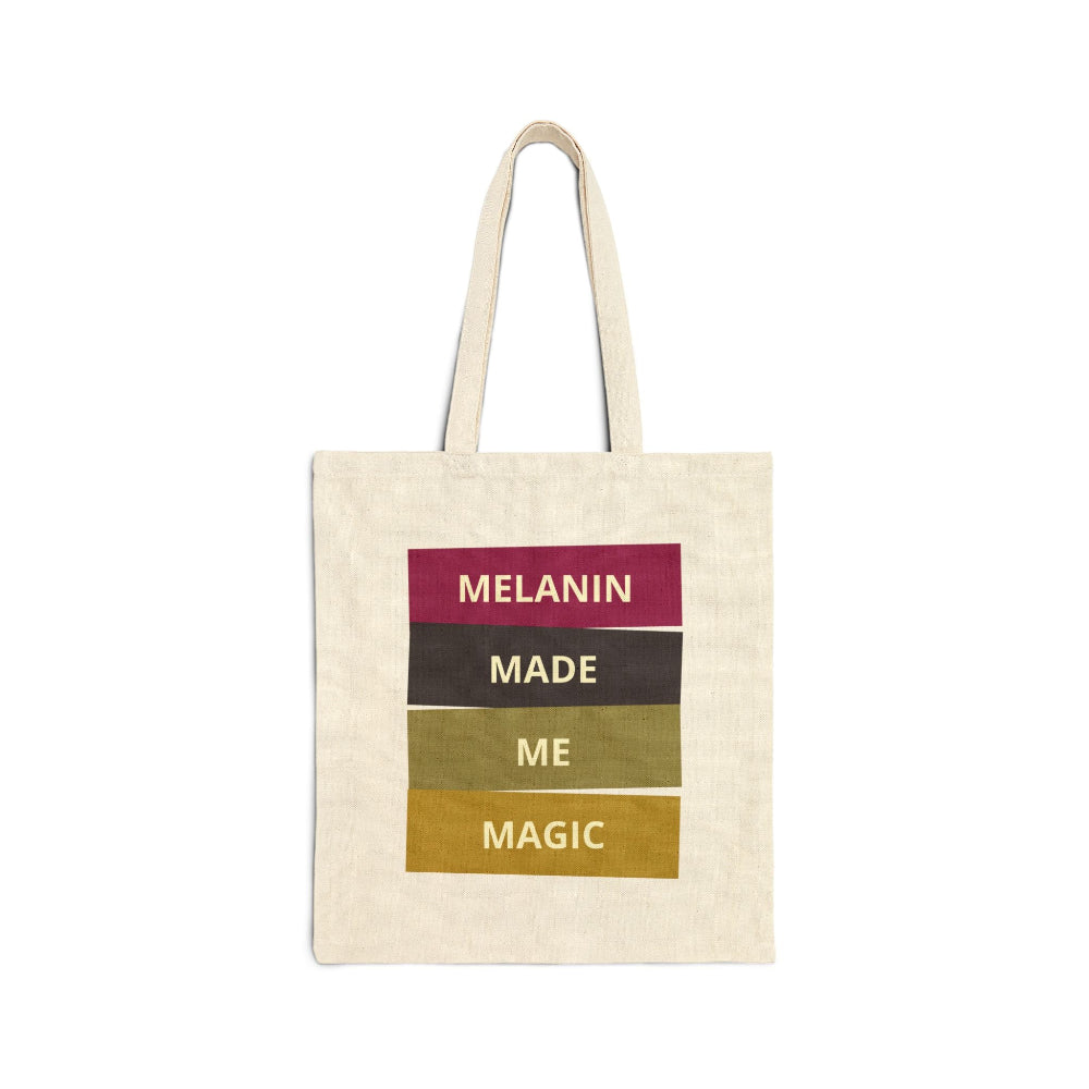 Canvas tote bag with "MELANIN MADE ME MAGIC" graphic in maroon, black, olive, and mustard color blocks.