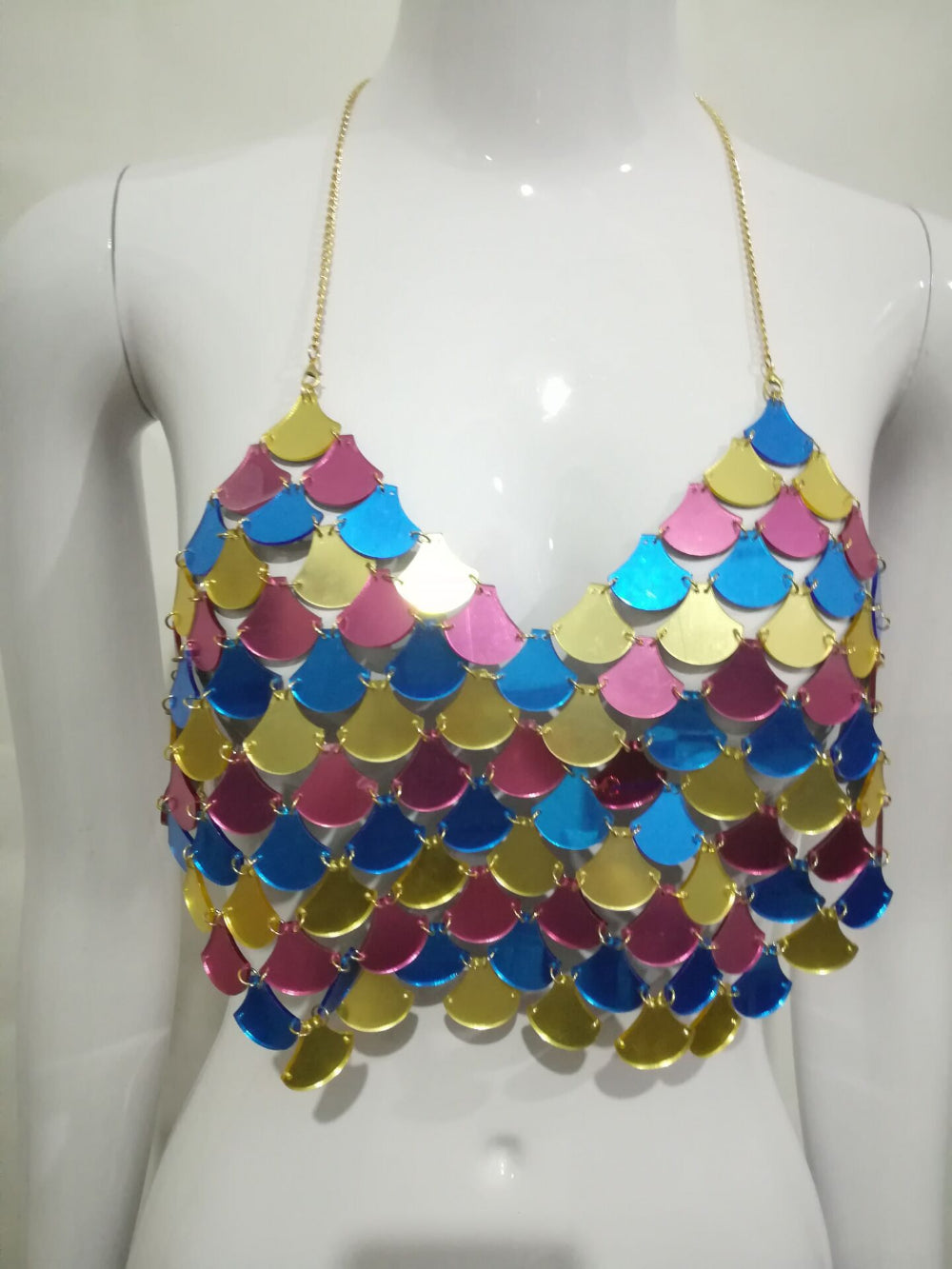Multicolor sequin scale-pattern halter crop top in pink, blue, yellow and gold, displayed on a mannequin.
