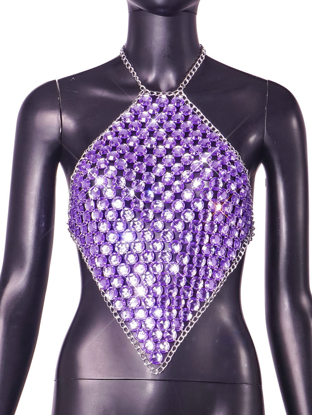 Purple rhinestone halter top with diamond-shaped crystal embellishment and chain neck strap, displayed on a black mannequin.