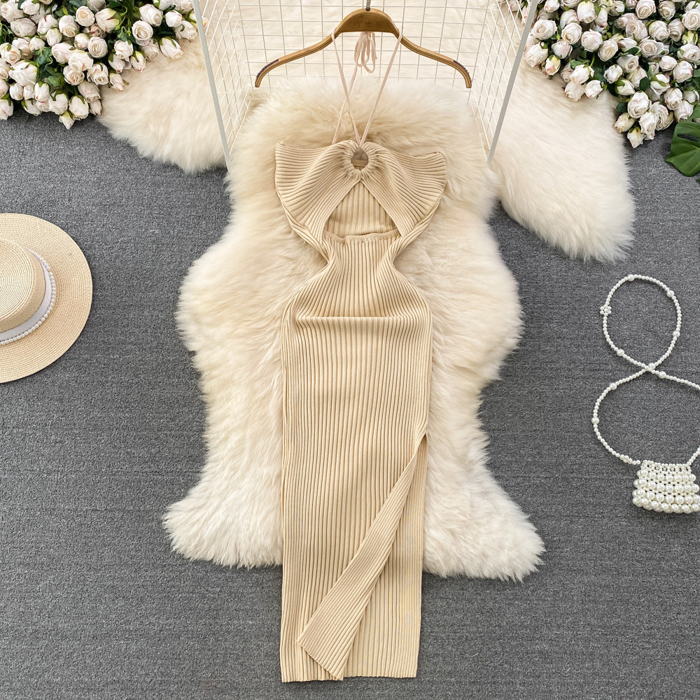 Cream ribbed knit halter maxi dress with front keyhole cutout on wooden hanger.