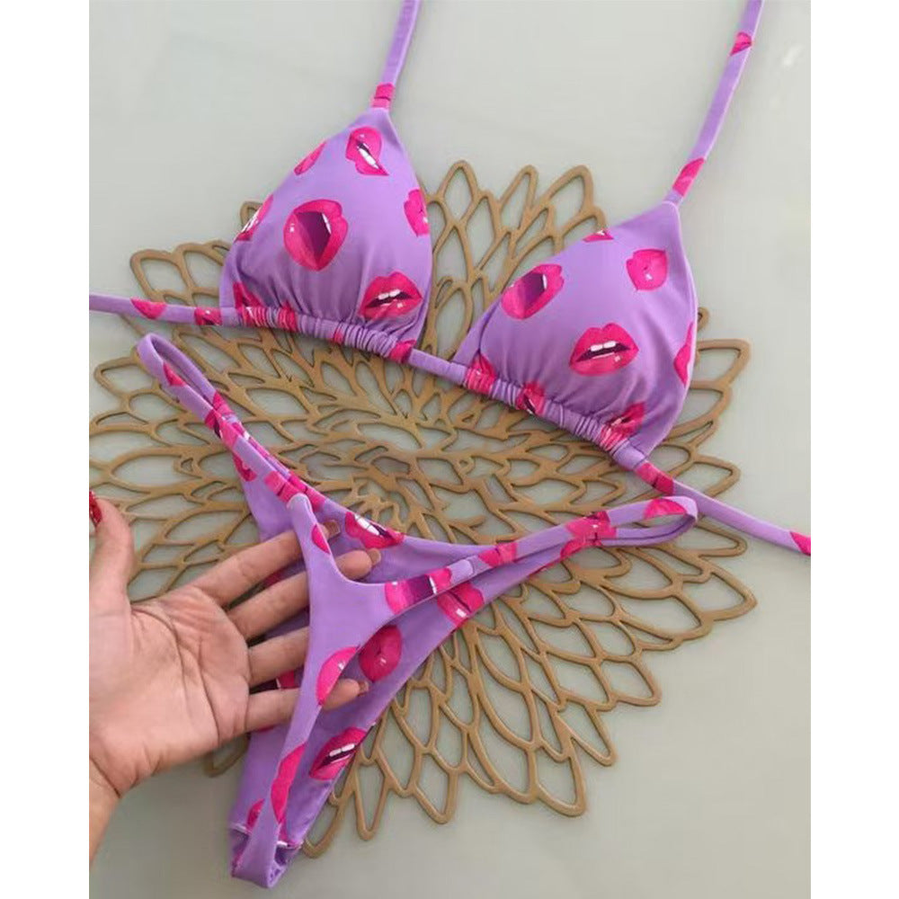 Purple bikini with pink lip designs on a decorative mat