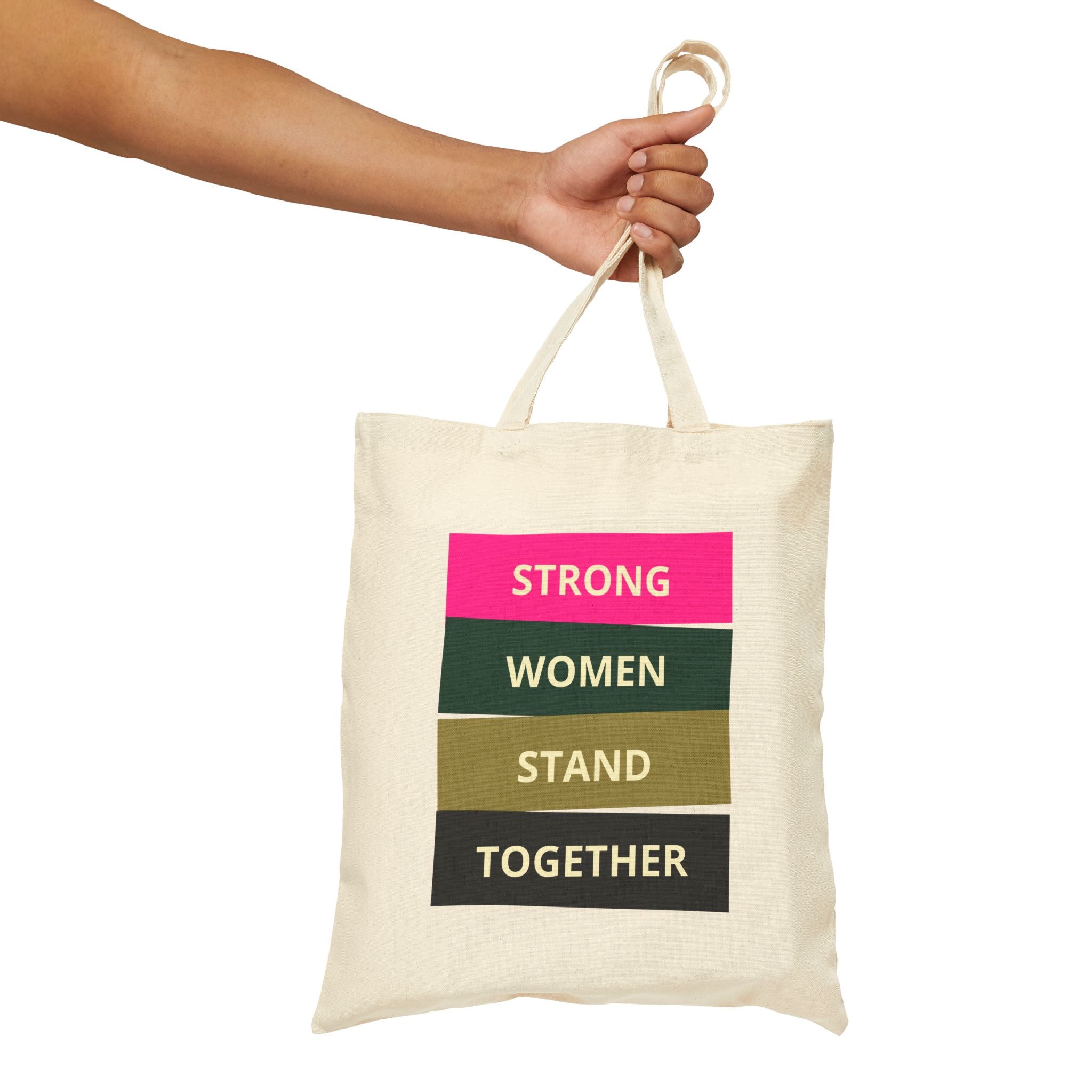 White Tote bag with motivational quote held by a hand on a white background