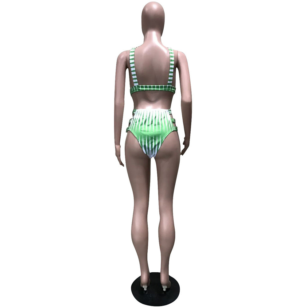 Mannequin wearing a green and white striped swimsuit on a white background