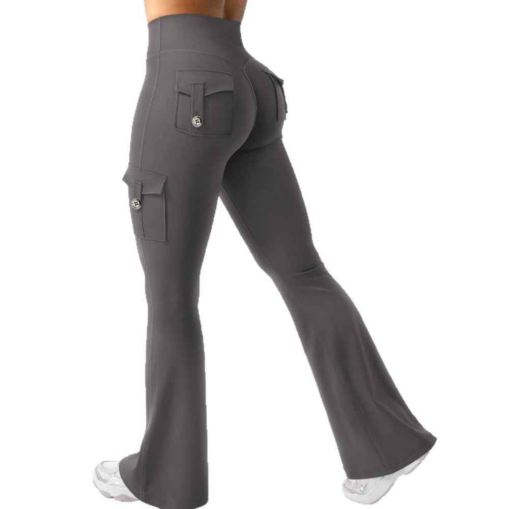 Woman modeling dark grey high-waisted flared cargo pants with side and back pockets, shown from a rear three-quarter view against a clean white studio background.