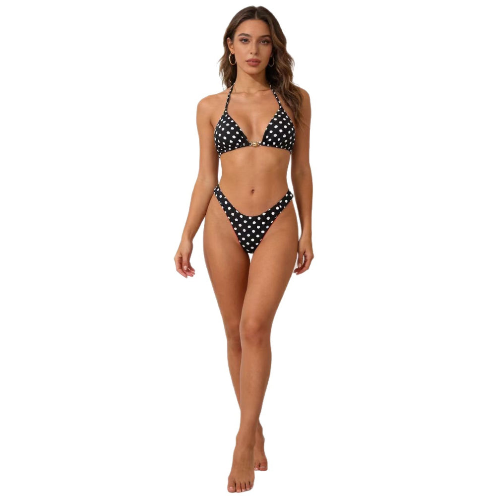 Woman wearing a black and white polka dot bikini on a white background