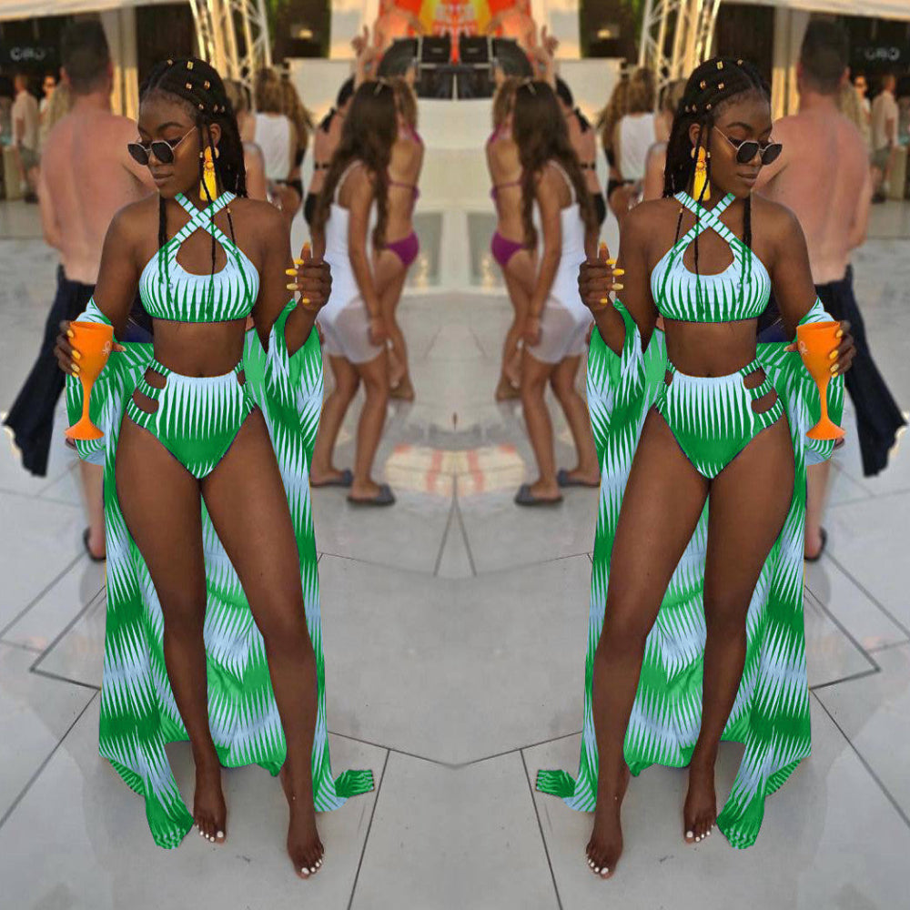 Two women in green and white swimwear with matching cover-ups standing on a tiled floor.