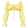 Yellow floral print cropped puff sleeve blouse on a white background. The square neckline features ruched elastic and a front tie drawstring, with voluminous long sleeves that have smocked elastic cuffs.