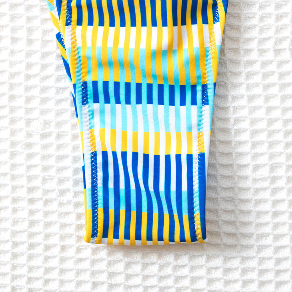 Striped chair with blue and yellow pattern on a textured white background