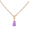 Sparkling silver tennis chain necklace featuring a fully pavé-style band and a bright purple translucent gummy bear pendant hanging from the center. Clean product photography on a plain white background.