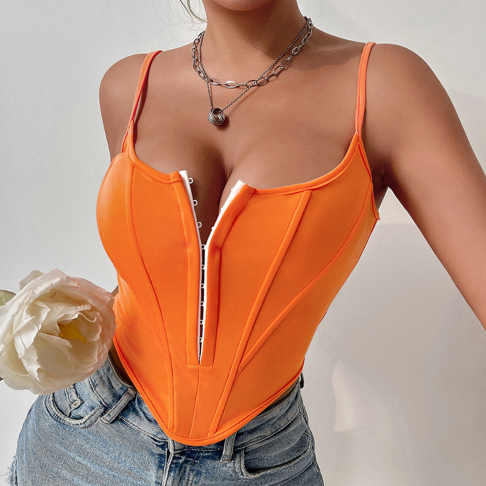 Woman wearing a vibrant orange corset-style bodysuit with front zipper closure and structured boning for a flattering fit. Styled with layered silver chain necklaces and light-wash denim jeans while holding a white flower.