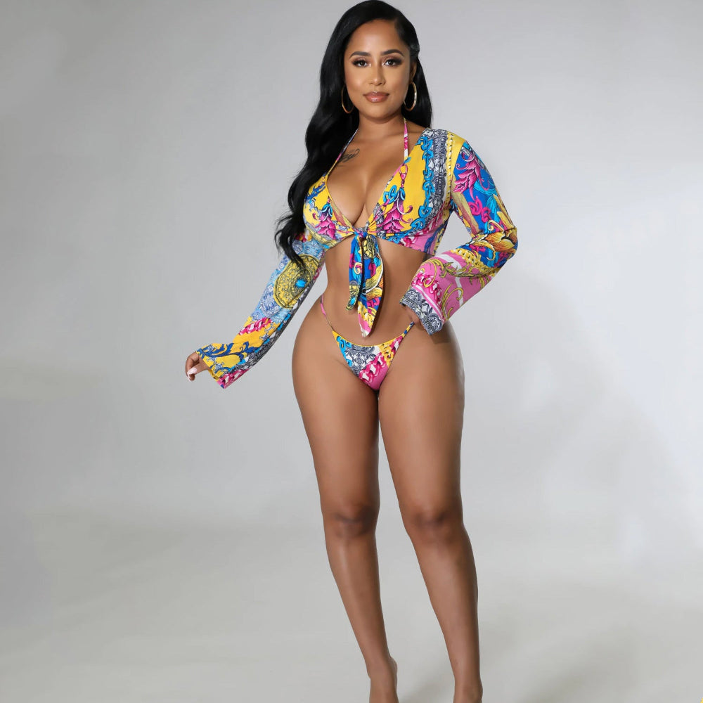 Woman wearing a colorful patterned swimsuit on a plain background