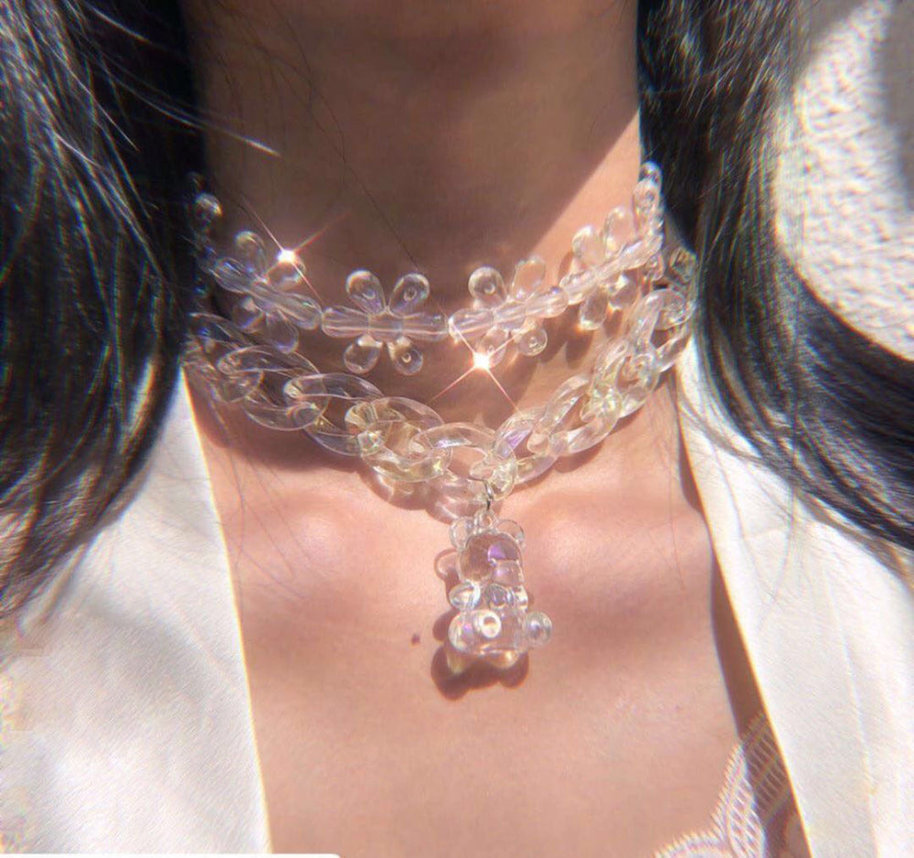Transparent floral acrylic necklace on model – trendy clear flower chain choker with pendant, sparkling statement jewelry.