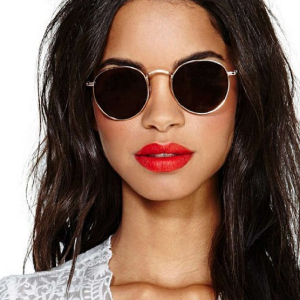 Classic silver metal round sunglasses featuring dark smoke tinted lenses, worn by model