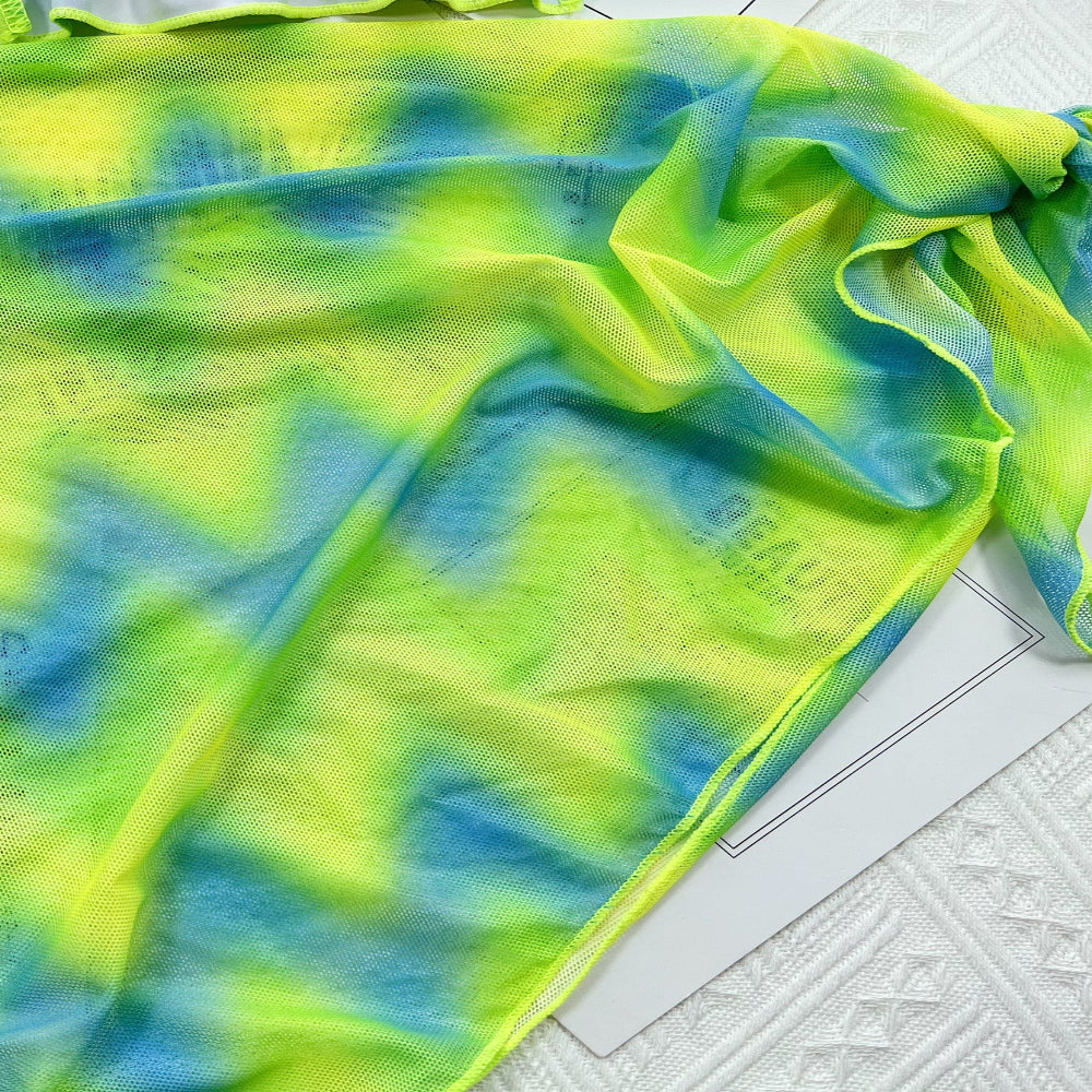Green and blue tie-dye fabric on a white floor