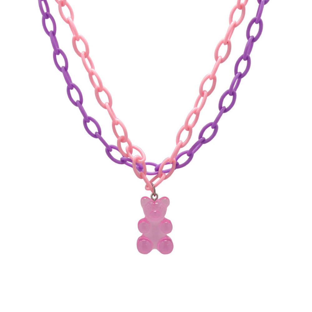 Double-strand chain necklace in pastel pink and purple with a translucent pink gummy bear pendant. Playful and bold statement choker-style piece displayed on a clean white background.