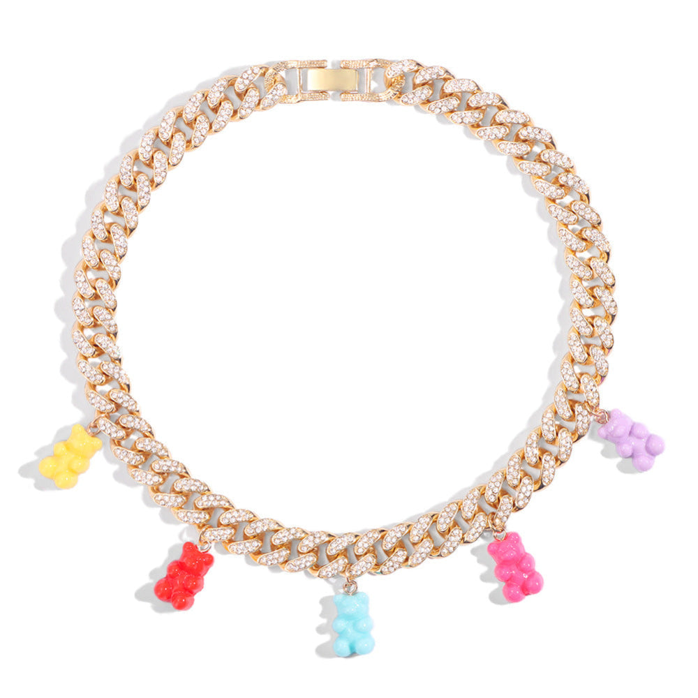 Gold Cuban link choker necklace fully iced with sparkling cubic zirconia stones, featuring colorful gummy bear charms in yellow, red, light blue, pink, and purple.