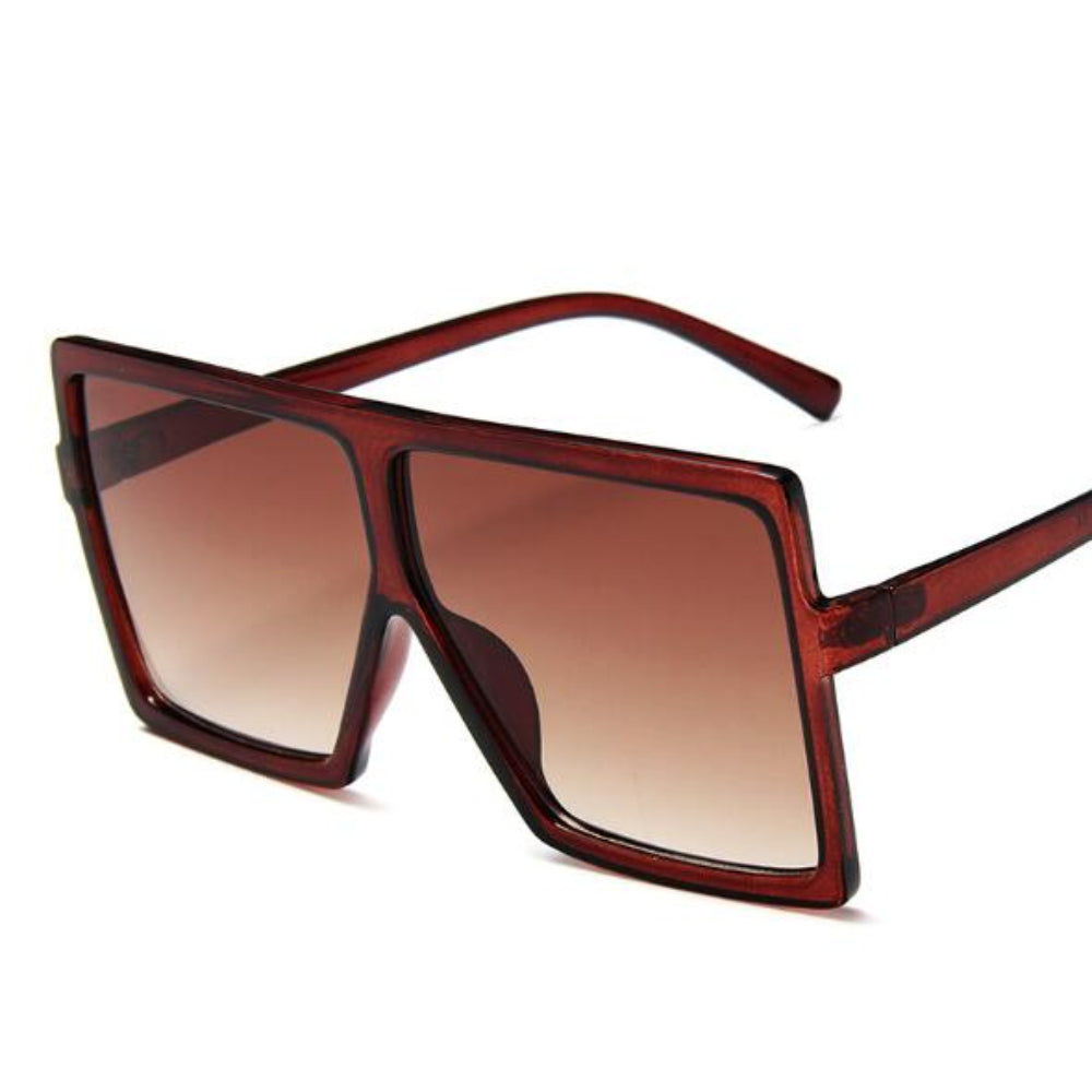 Brown sunglasses with a gradient lens on a white background