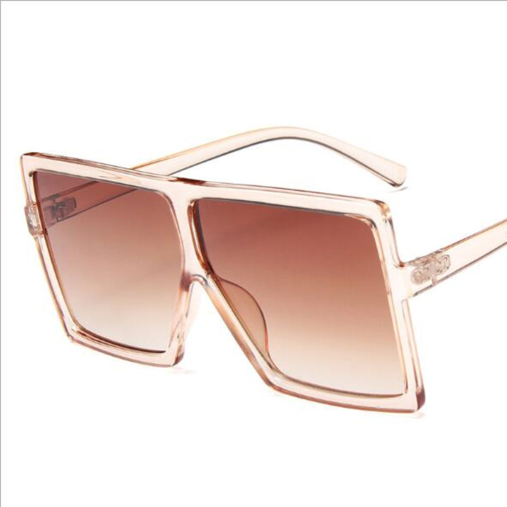 Sunglasses with rose gold frame and brown gradient lenses on a white background