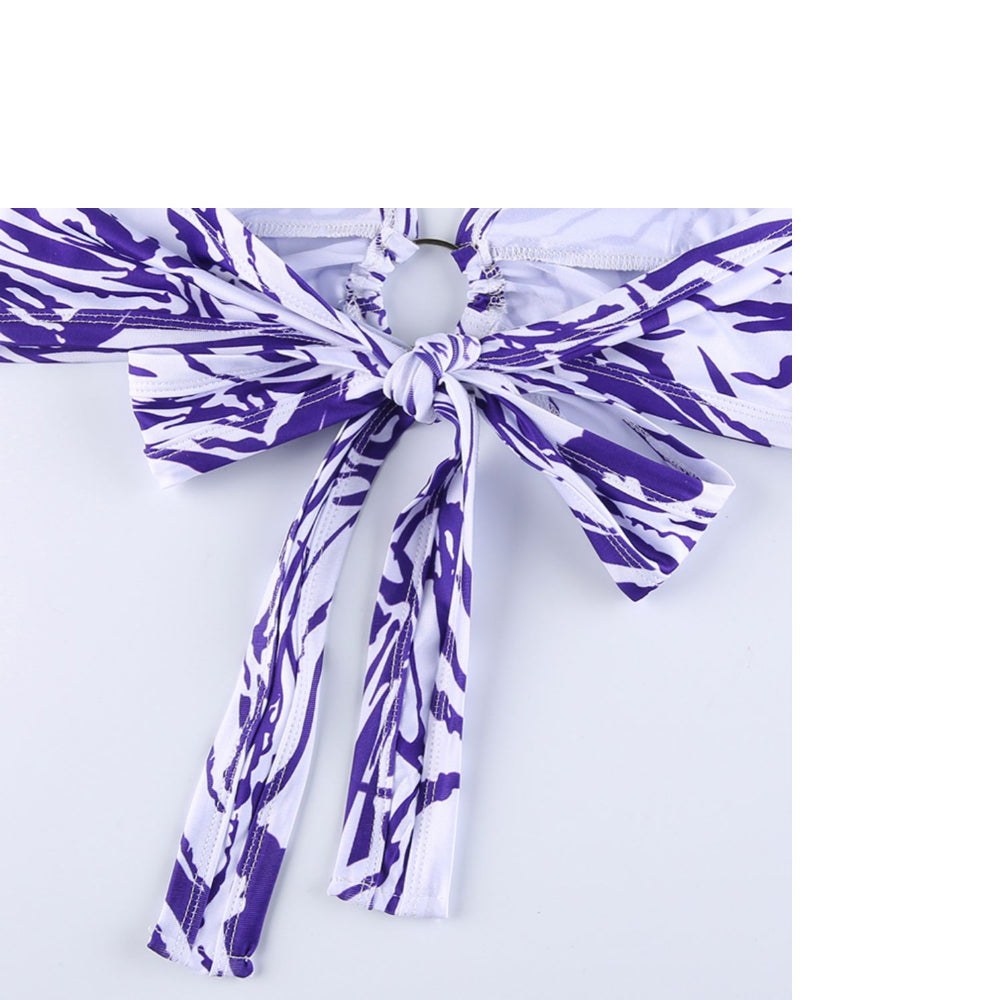 Purple and white patterned belt with a knot on a light purple background