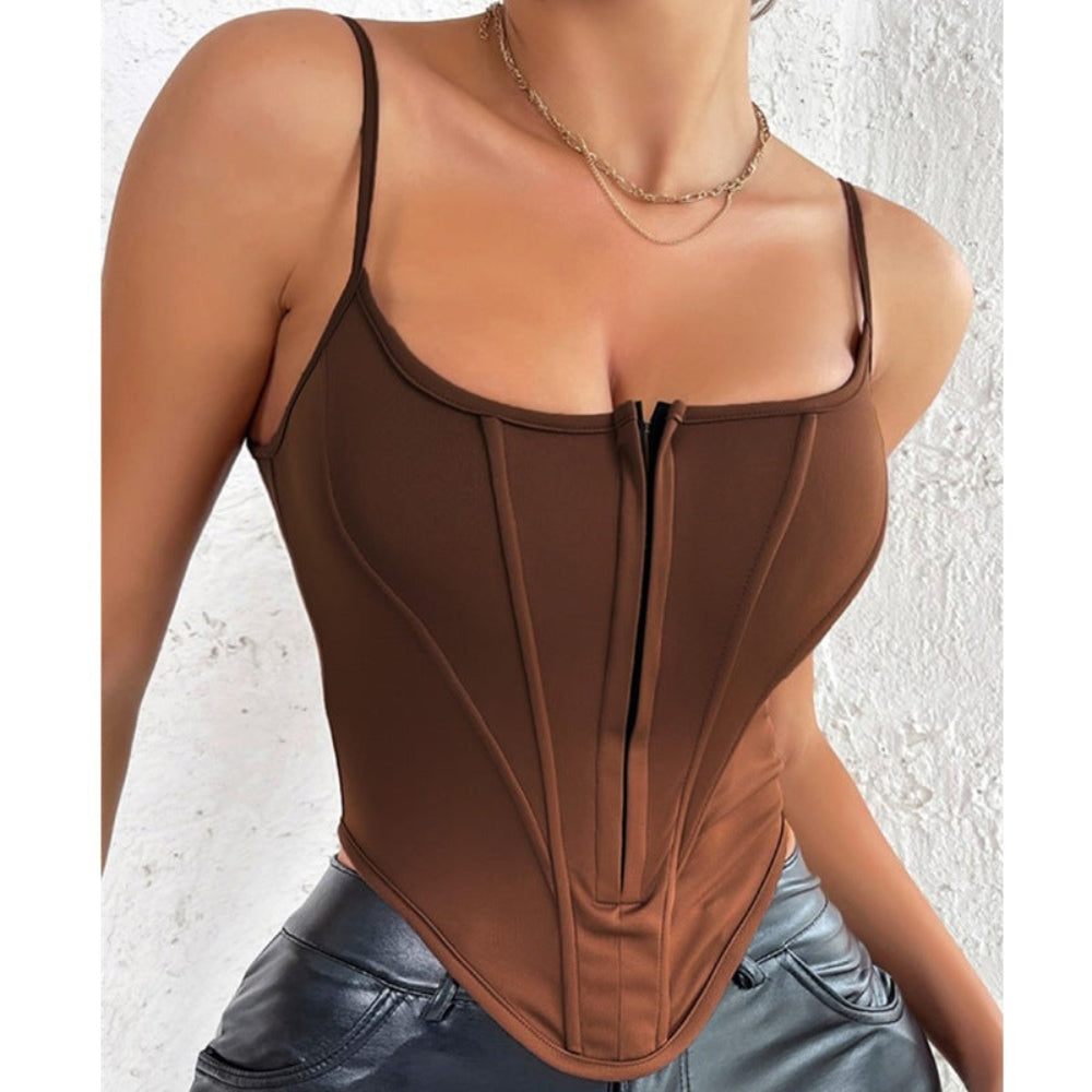 Woman wearing a chocolate brown corset-style bodysuit with front zipper closure and structured boning for a sculpted, curve-hugging fit. Paired with shiny black pants and layered gold chain necklaces, posing against a textured white background.