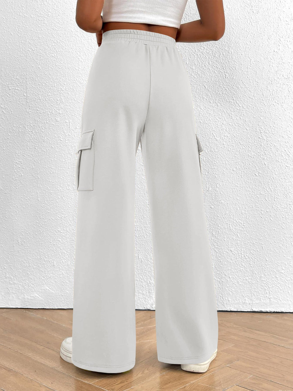 Light gray cargo pants worn by a person on a white background