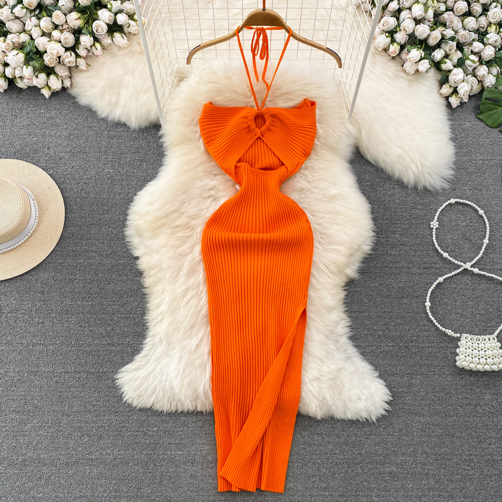 Bright orange ribbed knit halter maxi dress with front keyhole cutout on wooden hanger.