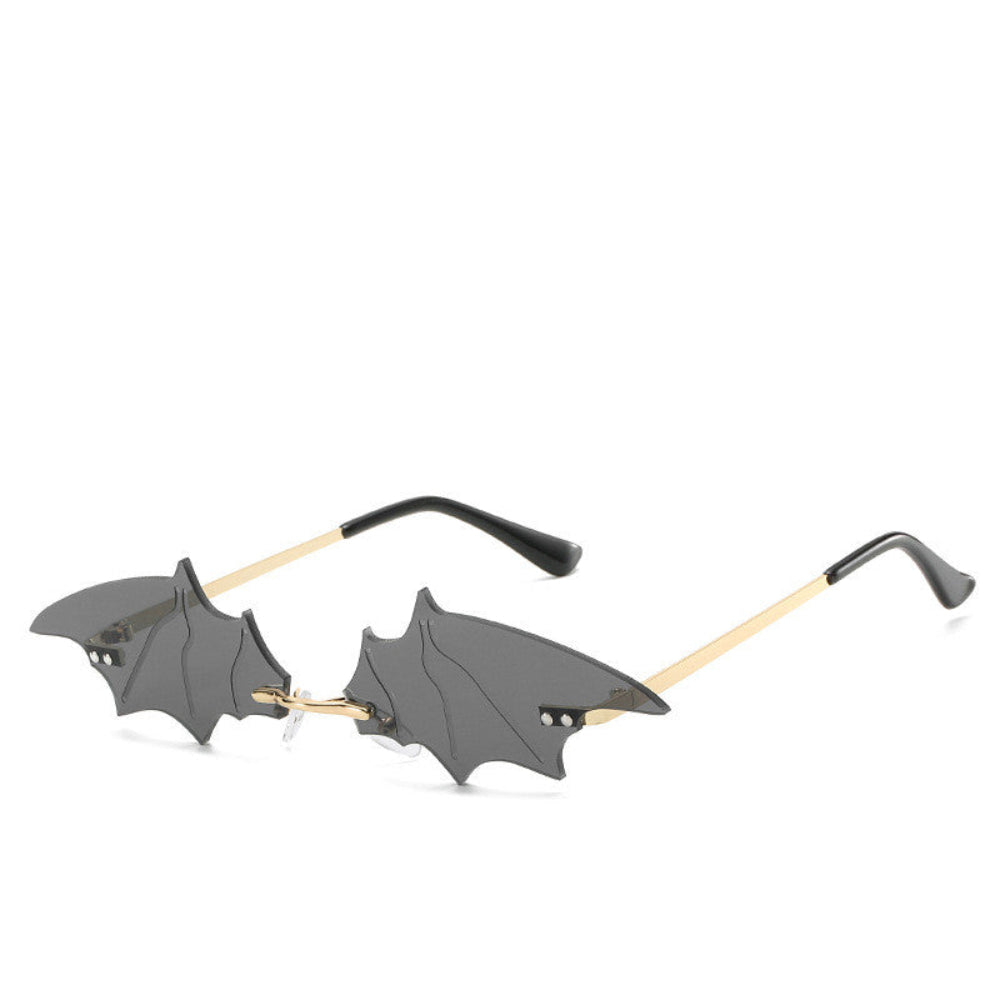Rimless dark-gray bat-wing sunglasses with gold temples, product photo on a white background.