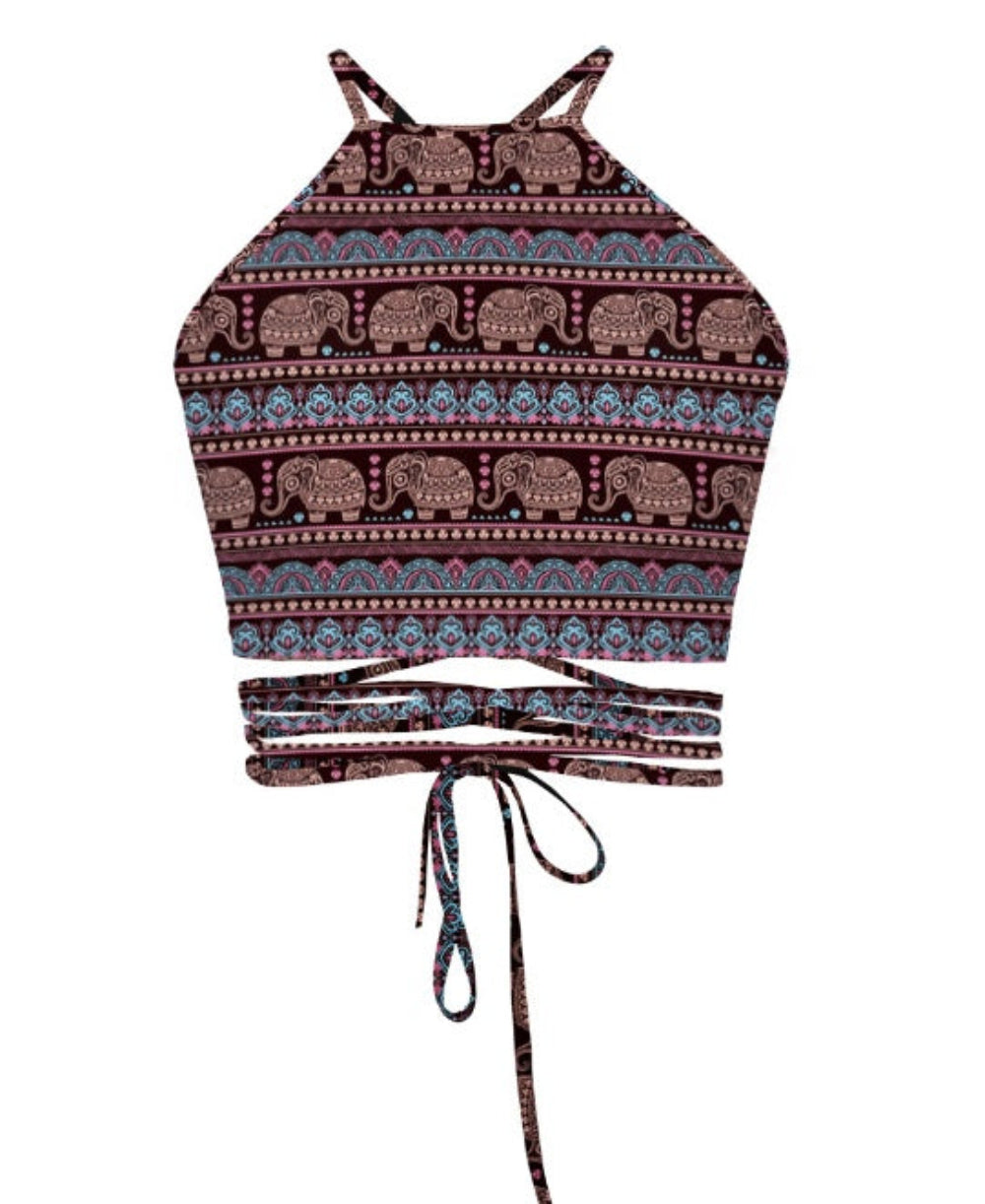 Dark elephant print halter crop top with tribal pattern and multi-strap tie-back detail, shown flat lay on white background.