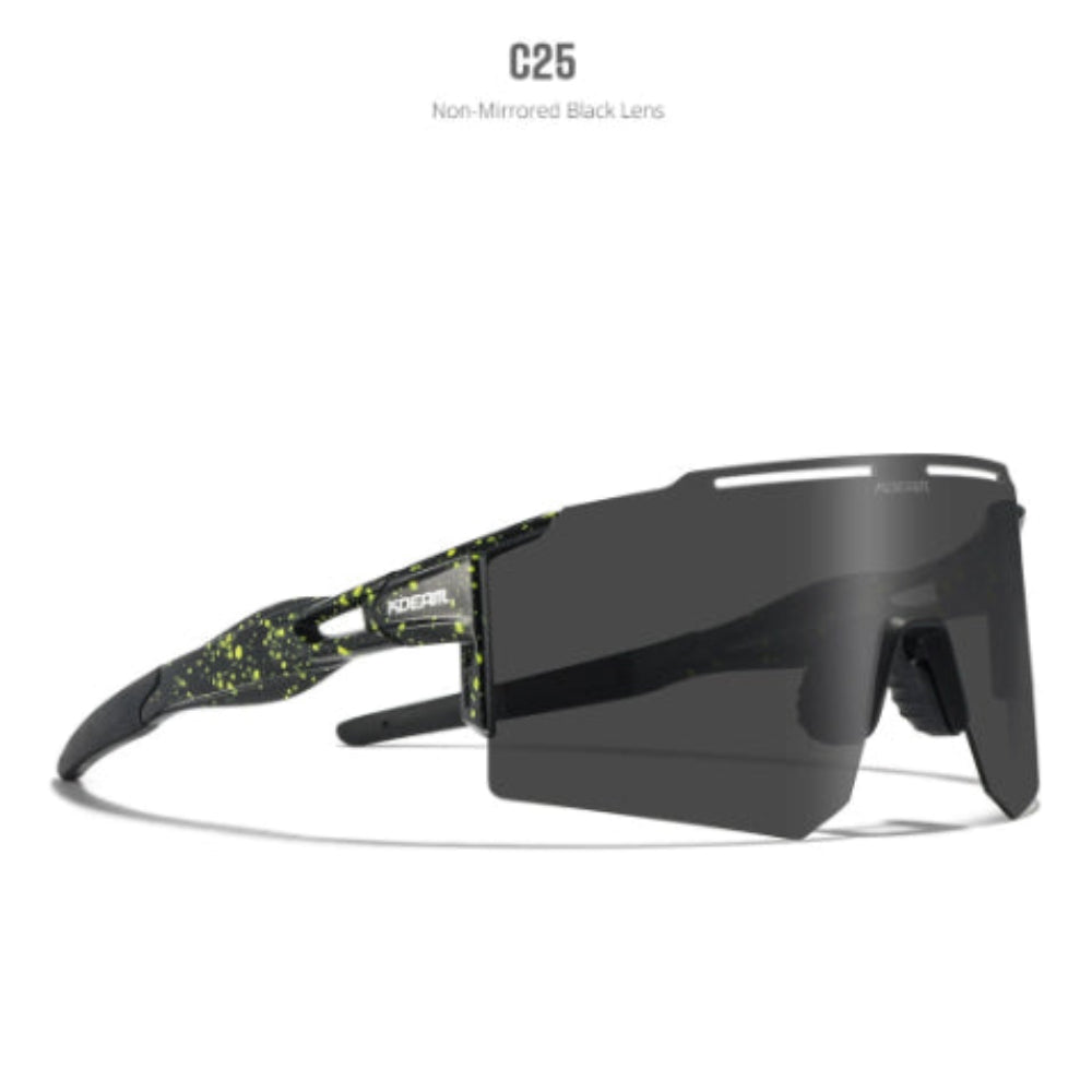 Oakley sunglasses featuring a matte black frame with vibrant neon yellow/green splatter details, paired with a large dark smoke mirrored shield lens
