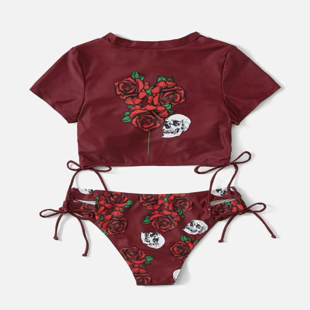 Maroon bikini set with rose and skull designs on a white background