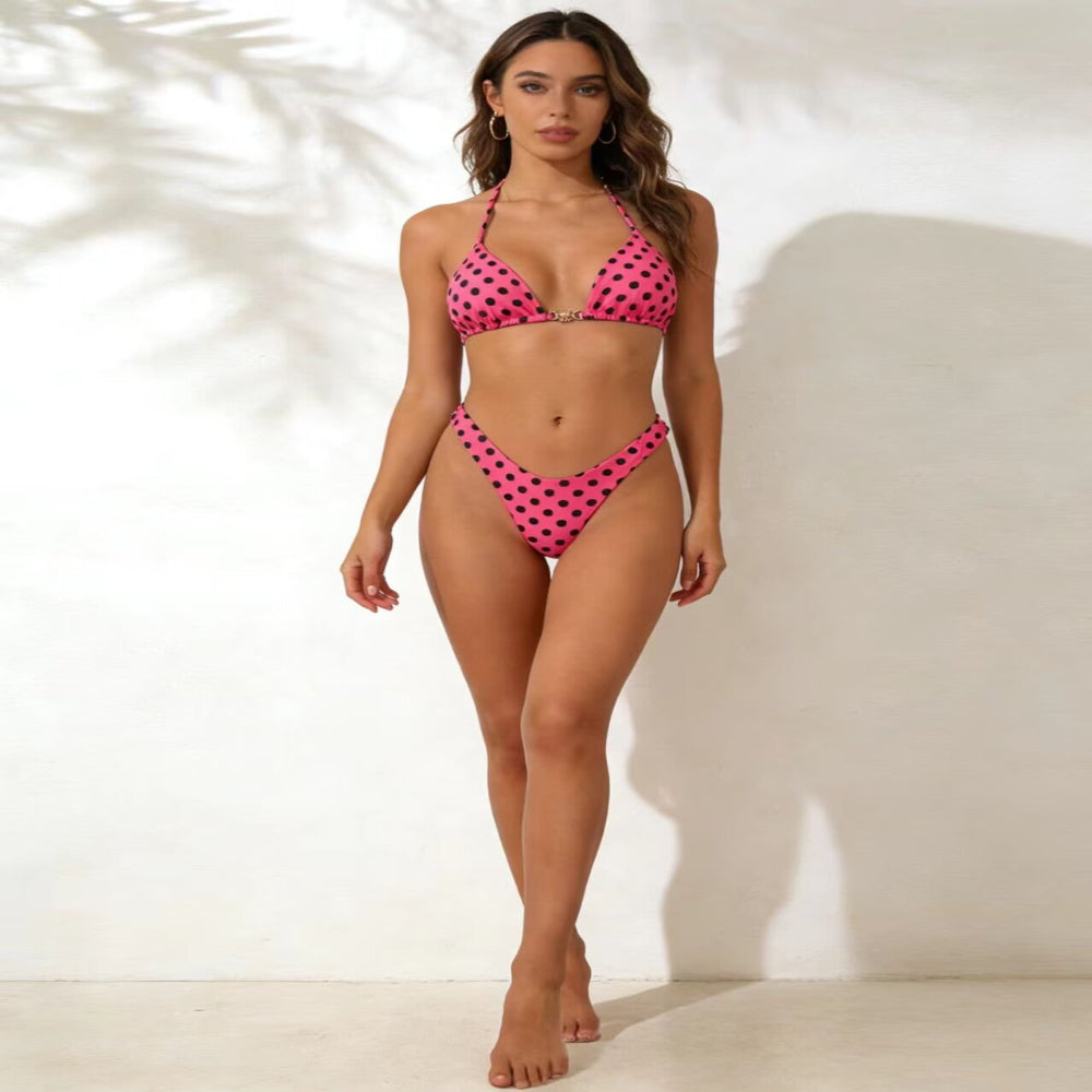 Woman wearing a pink polka dot bikini against a white background
