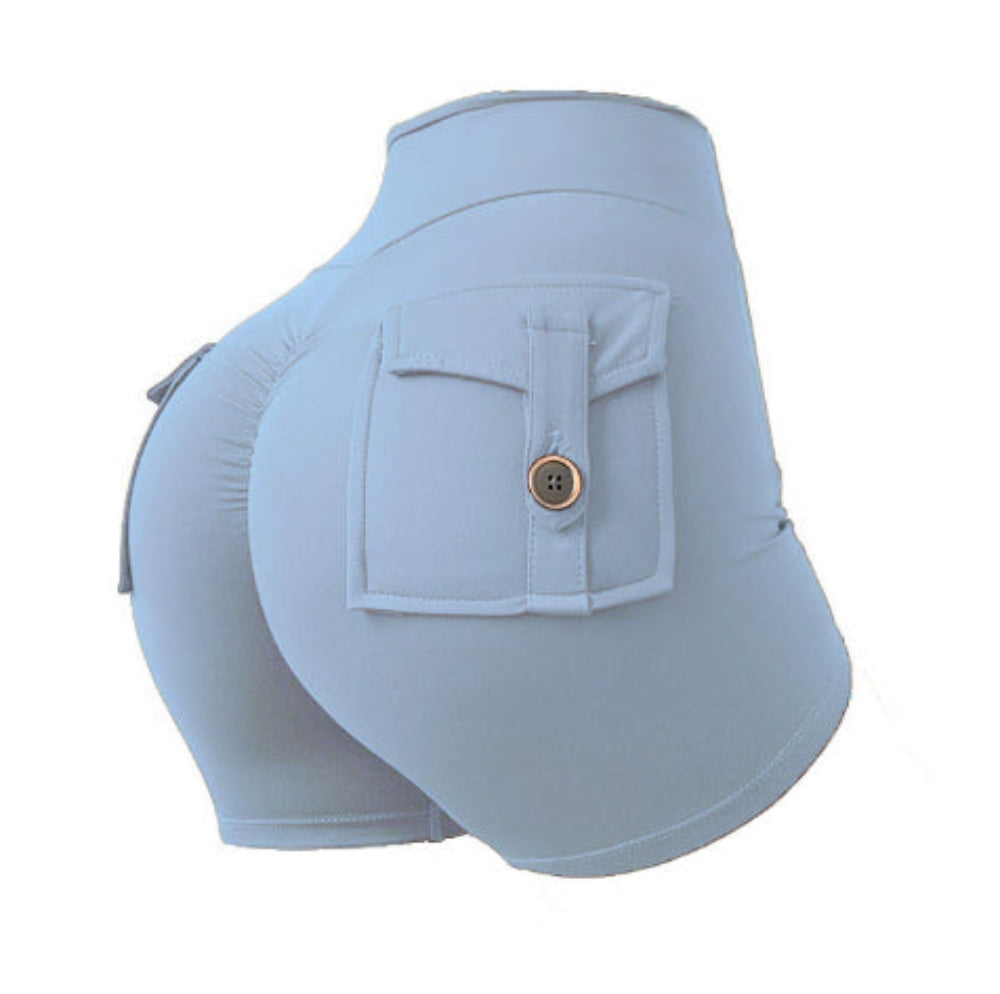 Woman modeling light blue high-waisted athletic cargo shorts with a large back flap pocket and button detail, shown from a rear three-quarter view against a clean white studio background.
