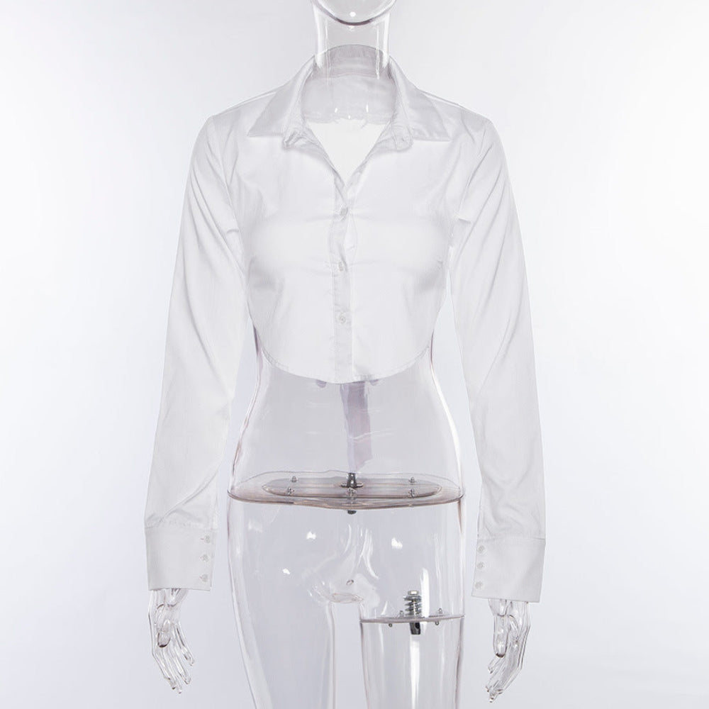 White cropped long-sleeve button-up shirt on a transparent mannequin featuring a classic collar, front button placket, and fitted cropped hem with button cuffs.