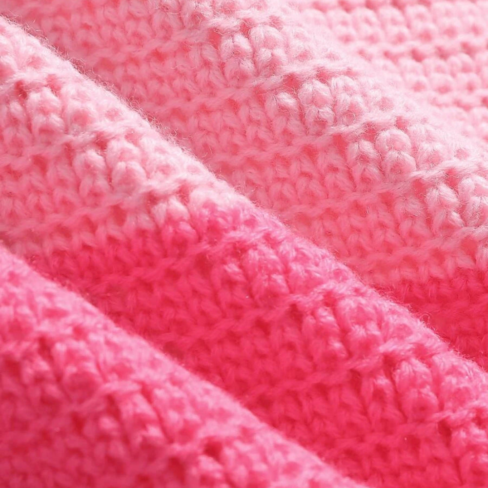 Extreme close-up detail of pink ribbed knit fabric texture. Boutique Jolie summer apparel.