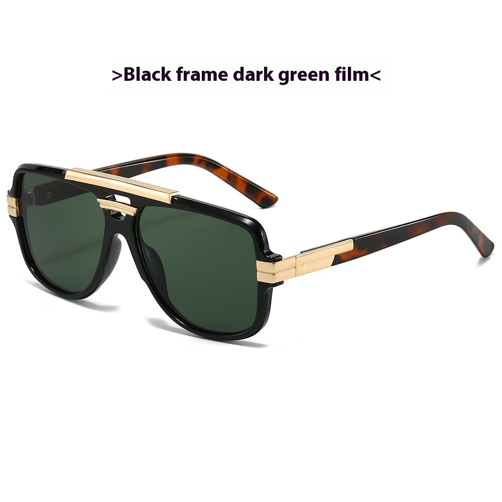 Black square retro sunglasses with gold brow bar, tortoiseshell temples, and dark green lenses, product photo on a white background.