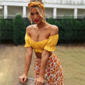 Yellow off-shoulder ruched crop top with puff sleeves, paired with a floral skirt and yellow headband, worn by a blonde model outdoors.