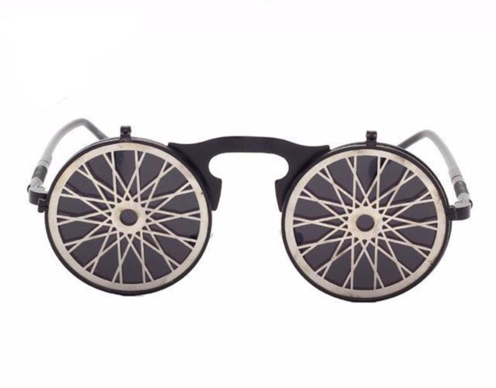 Black flip-up steampunk sunglasses with round bike-spoke metal covers over dark lenses, front product photo on a white background.