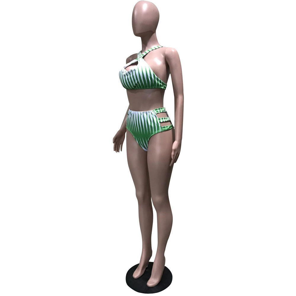 Mannequin wearing a green and white striped bikini on a white background