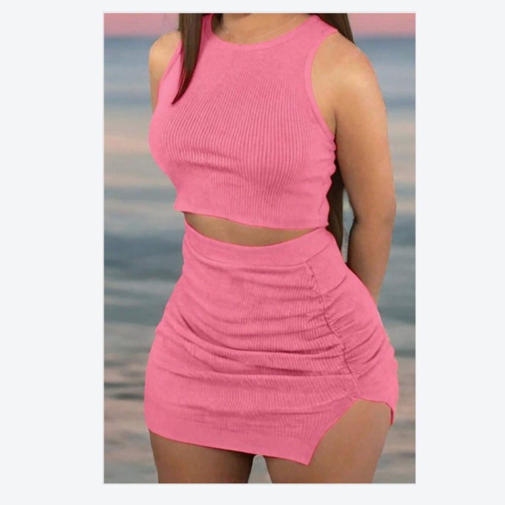 Person wearing a pink two-piece outfit on a beach.