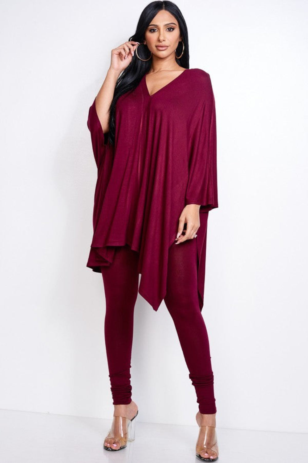 Woman wearing a burgundy outfit on a white background