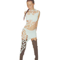 Model with braided hair wearing a bold avant-garde white outfit featuring multiple strategic cut-outs and web-like lattice patterns across the sleeveless top and high-low skirt. Styled with dark brown thigh-high boots, shown in a confident three-quarter pose on a clean studio background.