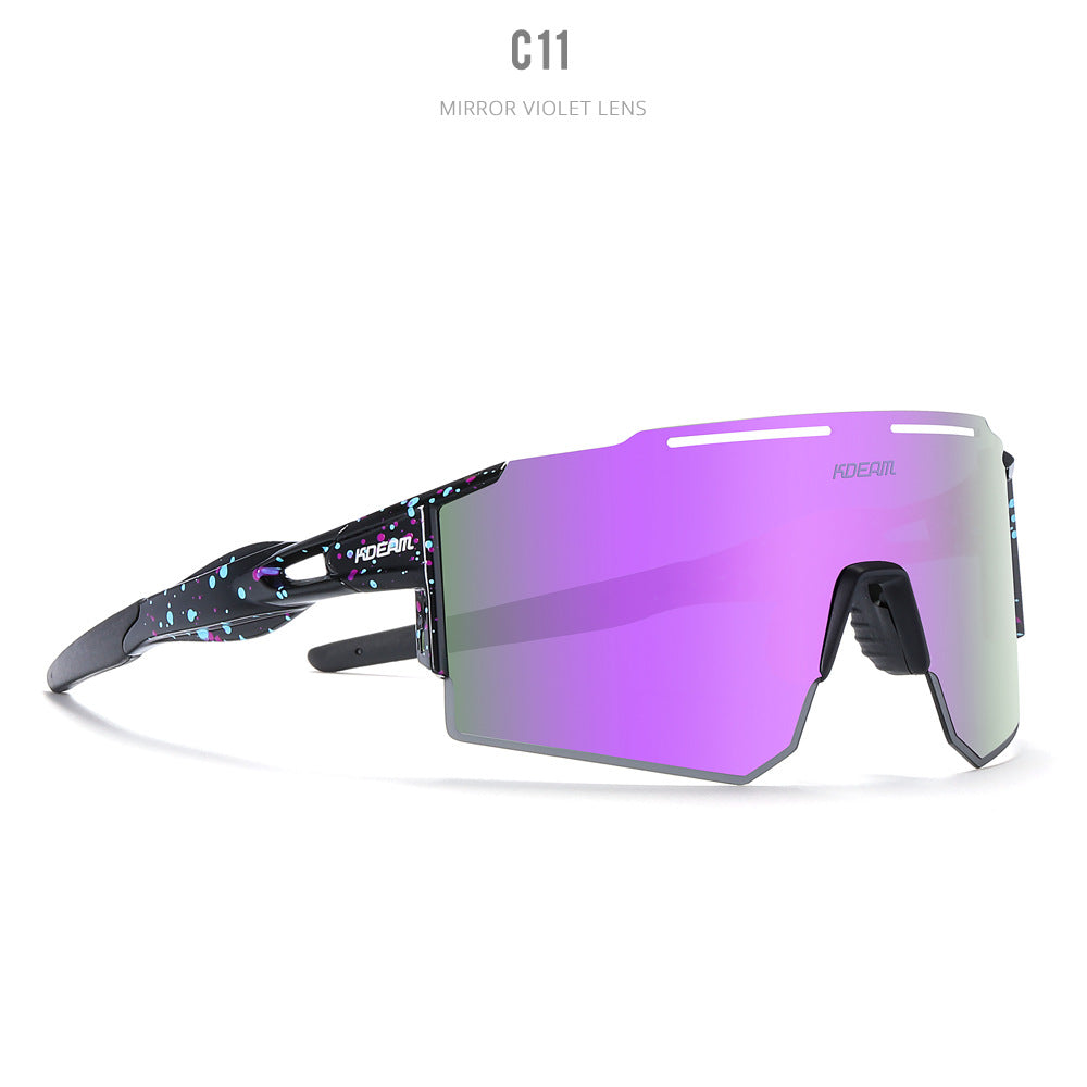 Futuristic black frame sport sunglasses with colorful blue and purple speckles featuring a large vibrant purple-to-pink iridescent mirrored shield lens and performance design