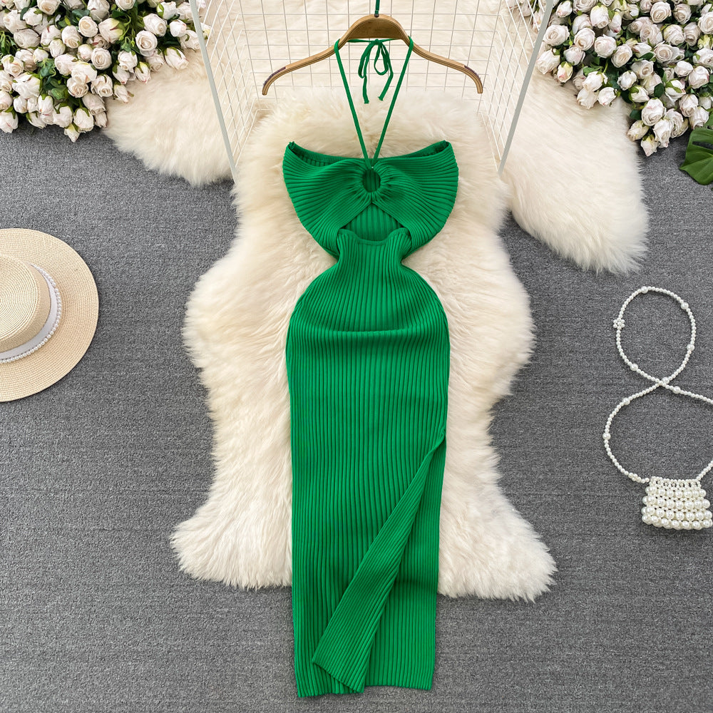 Emerald green ribbed knit halter maxi dress with front keyhole cutout on wooden hanger.
