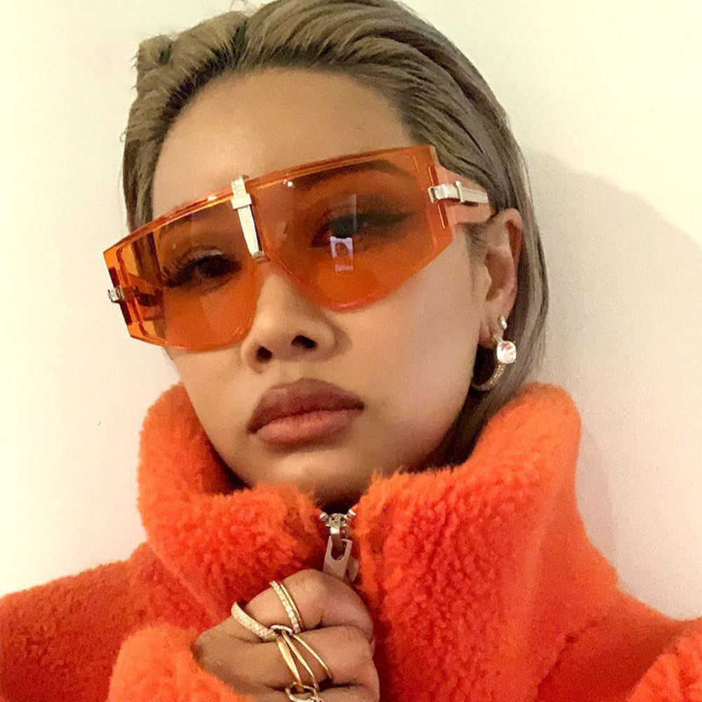 Orange oversized shield sunglasses with silver center bridge and orange tinted lenses