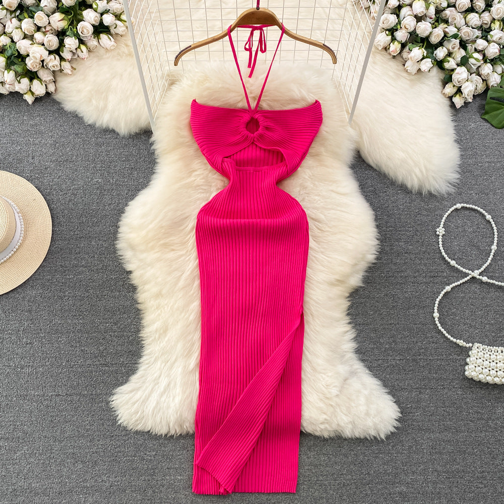 Vibrant pink ribbed knit halter maxi dress with front keyhole cutout on wooden hanger.