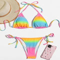 Rainbow tie-dye two-piece bikini set with triangle halter top and tie-side bikini bottom.