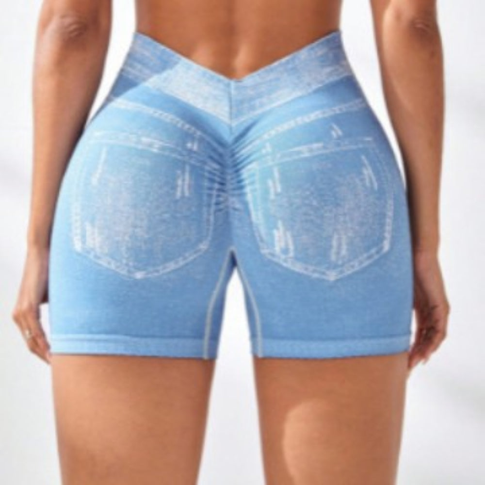Woman modeling light blue denim-style high-waisted stretch shorts with back pockets and white contrast stitching, shown from the back view against a clean white studio background.